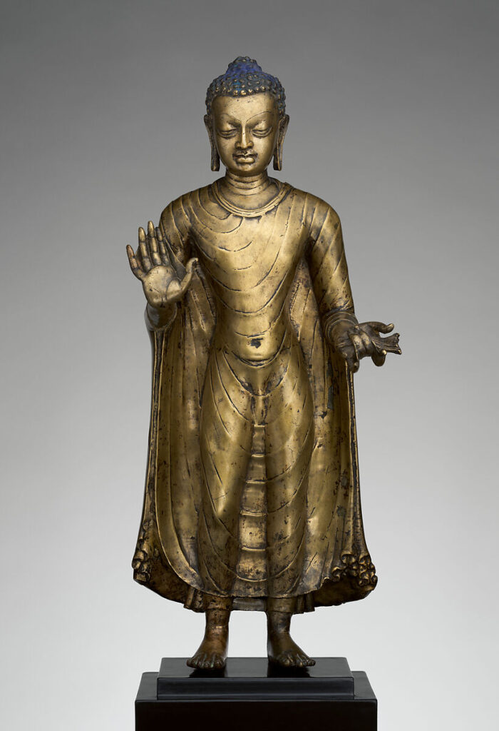 Buddha Offering Protection,” late 6th–early 7th century, copper alloy, India (probably Bihar), The Metropolitan Museum of Art. https://www.metmuseum.org/art/collection/search/38965
