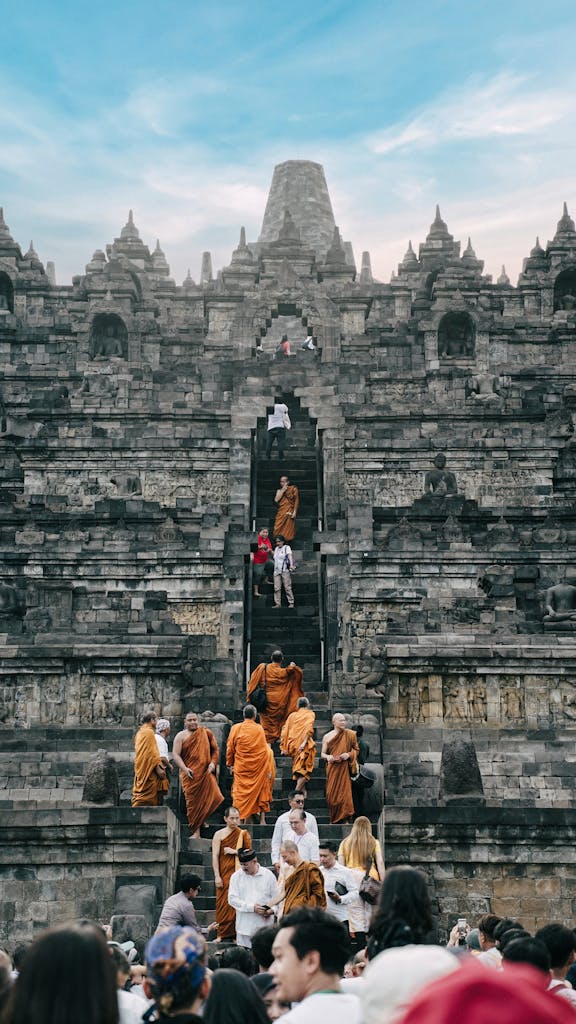 Buddhist monks participate in a ritual at Borobudur Temple, Indonesia, during a vibrant ceremony.