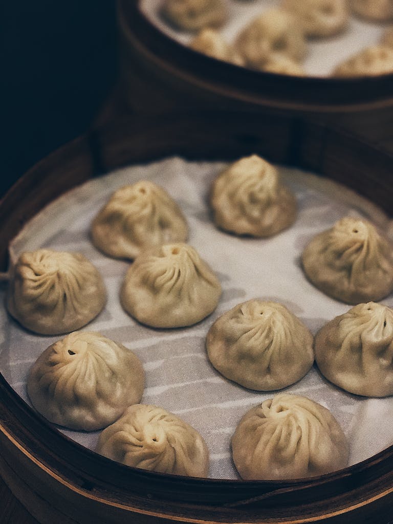 Close-up of traditional steamed dumplings in a bamboo steamer, showcasing delicious Chinese cuisine.