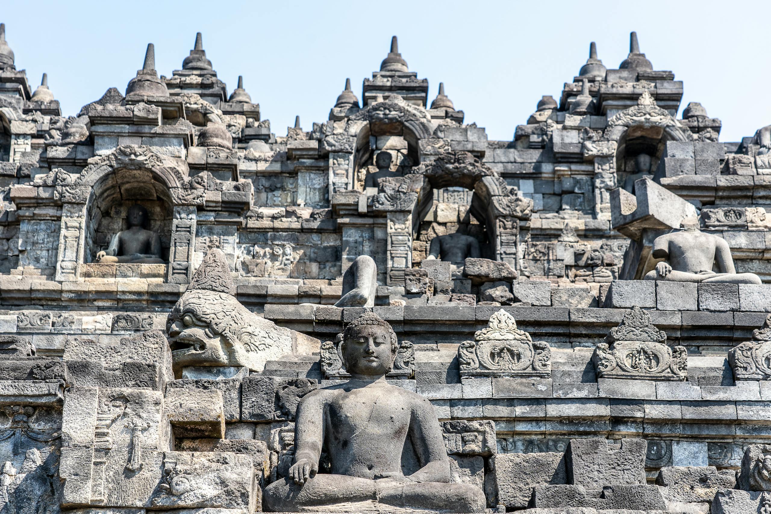 Close-up view of ancient stone sculptures and architecture at Borobudur Temple, Indonesia.