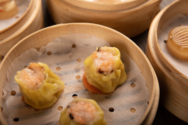 Delicious shumai dumplings in bamboo steamers, showcasing traditional dim sum cuisine.